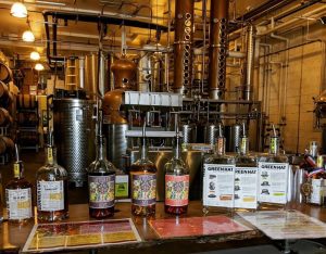 New Columbia Distillers - Green Hat Distilled Gin bottles and distillery