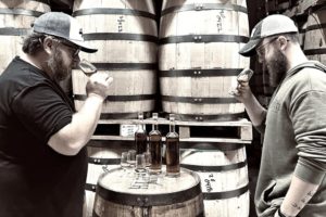 Hard Truth Distilling Co. - Master Distiller Bryan Smith nosing a barrel of Whiskey