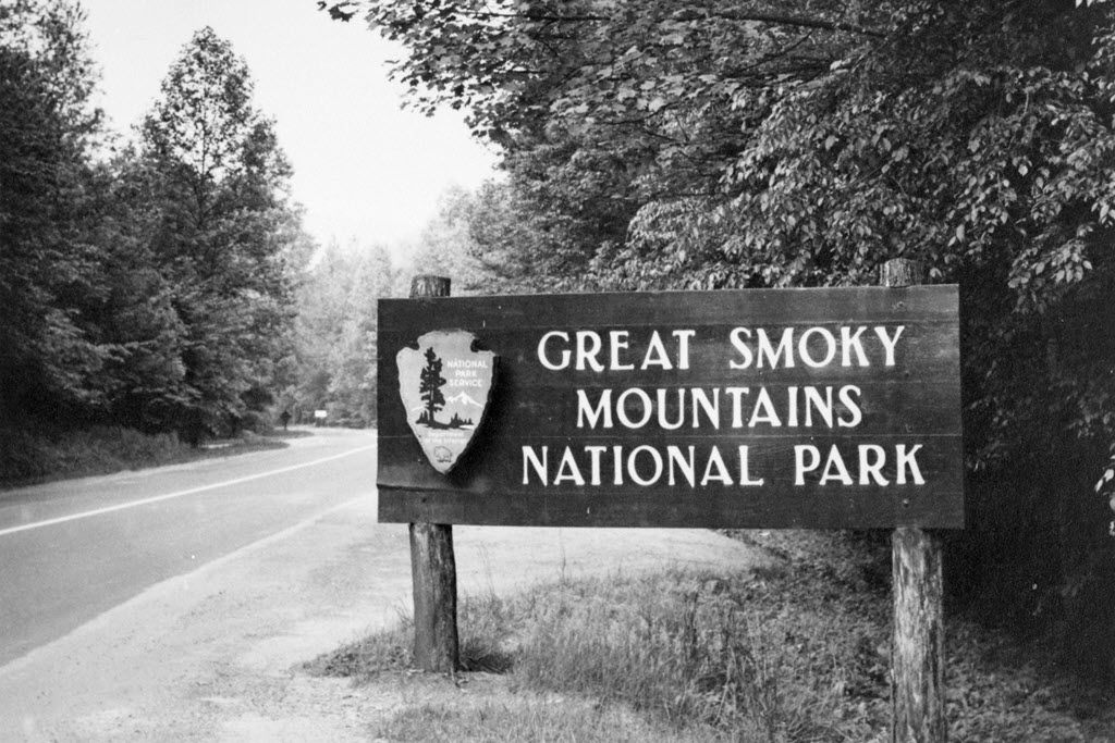 National Park Service - Great Smoky Mountains National Parks entrance sign along a road circa 1960