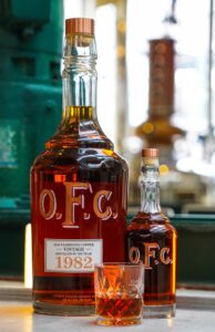 Buffalo Trace Distillery - Vintage 1982 6 Liter Bottle of O.F.C. Bourbon Whiskey Next to 750 Liter Bottle of O.F.C.