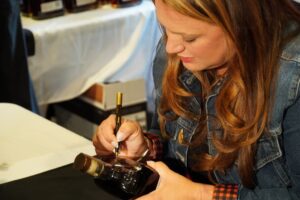 Woodford Reserve Distillery - Kentucky Derby Winning Trainer Cherie DeVaux Signing Bottles of Woodford Reserve